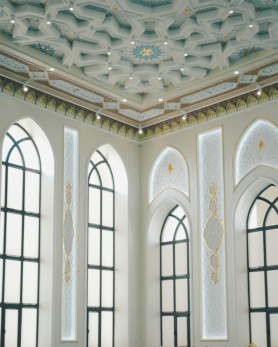 قاعة مسجد بنوافذ مقوّسة وسقف مزخرف